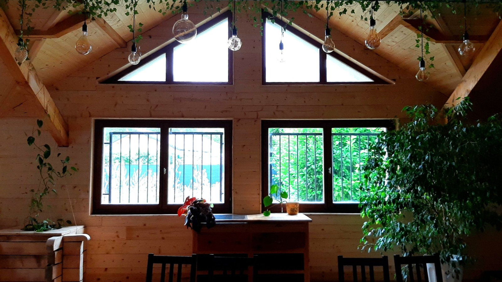 tables and plants in cafeteria space Les Sources