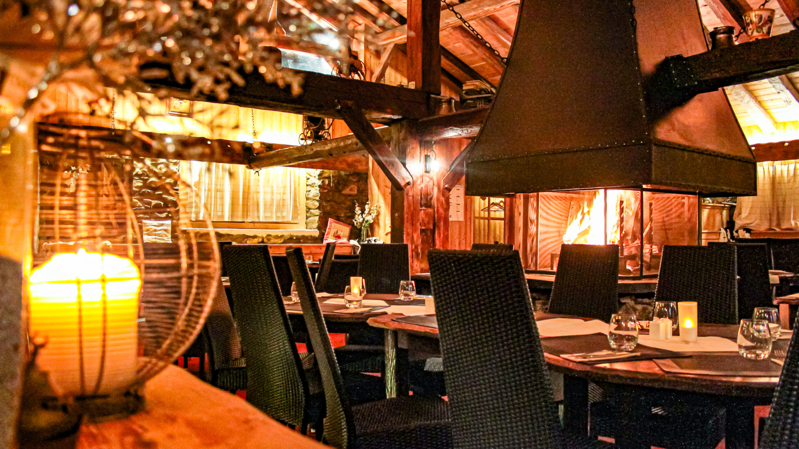 Inside the restaurant with a view of the central fireplace