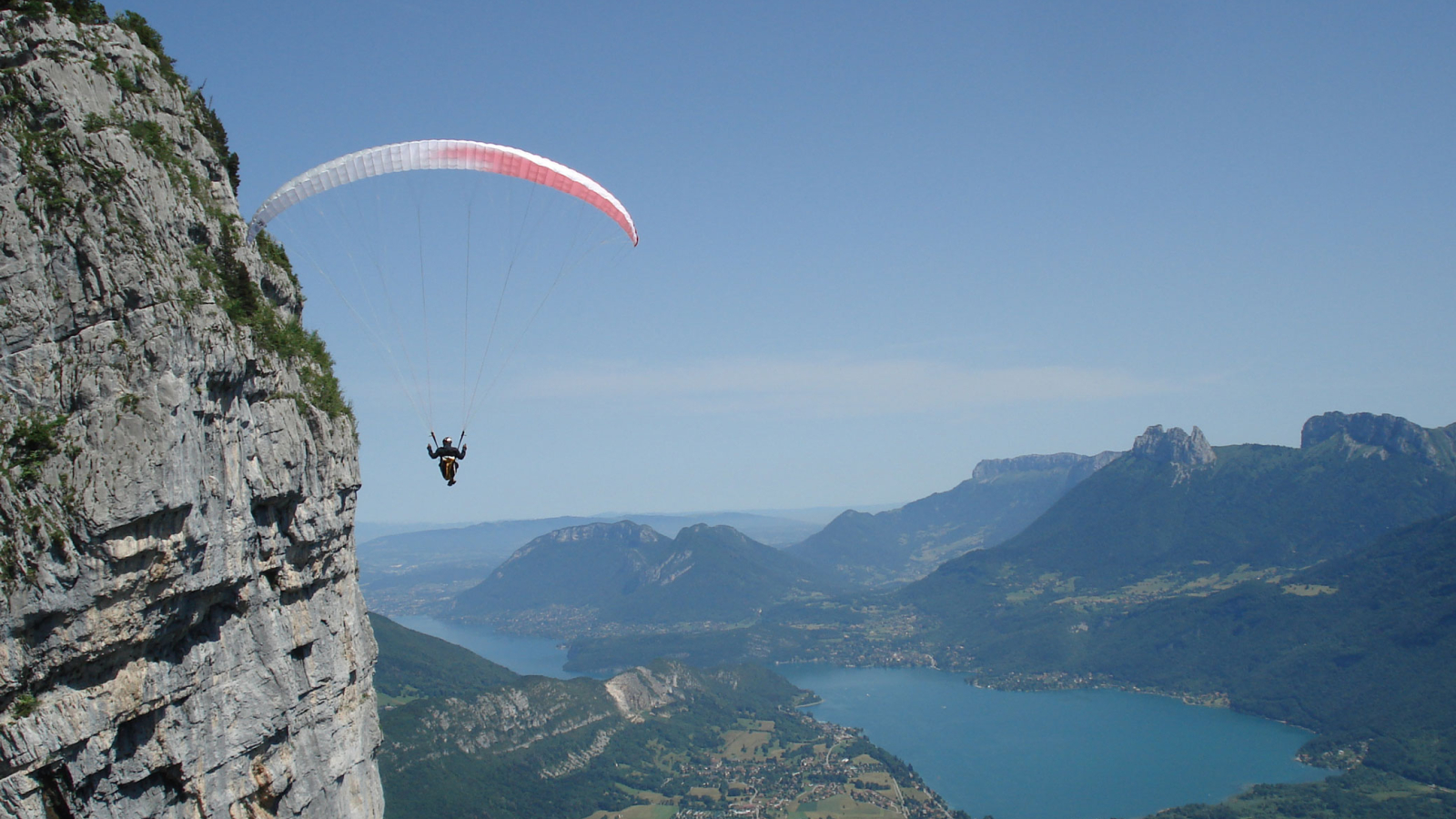 Paragliding flight above lake Annecy