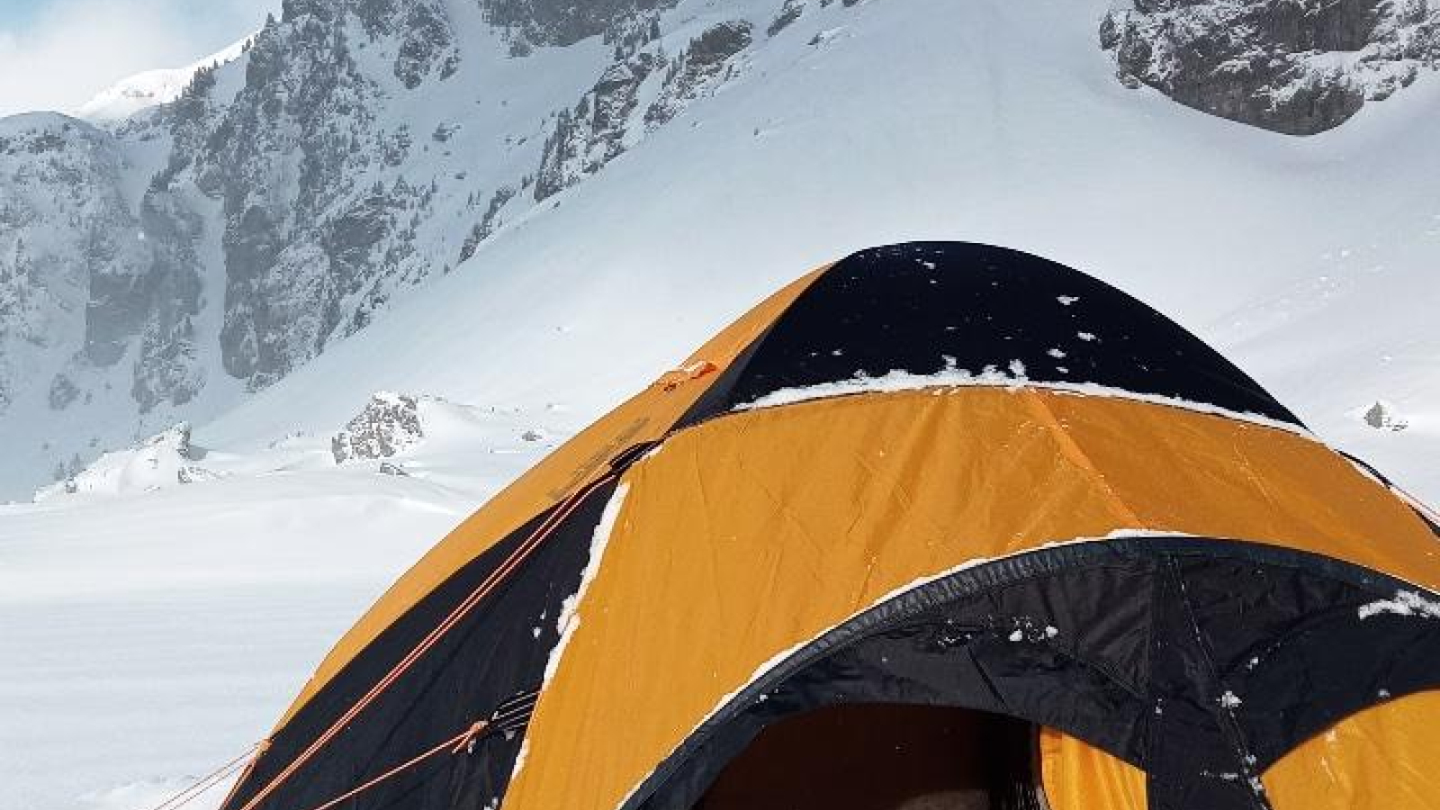 Unusual night in a tent on a frozen lake Chamrousse