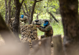 Deux personnes en plein tir dans la zone de paintball