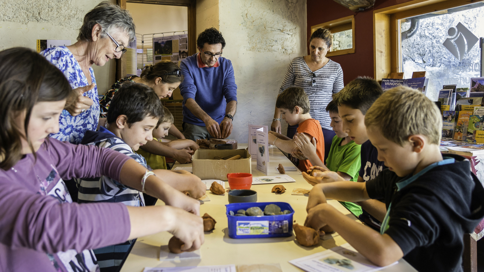 A group makes clay pottery