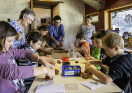 A group makes clay pottery