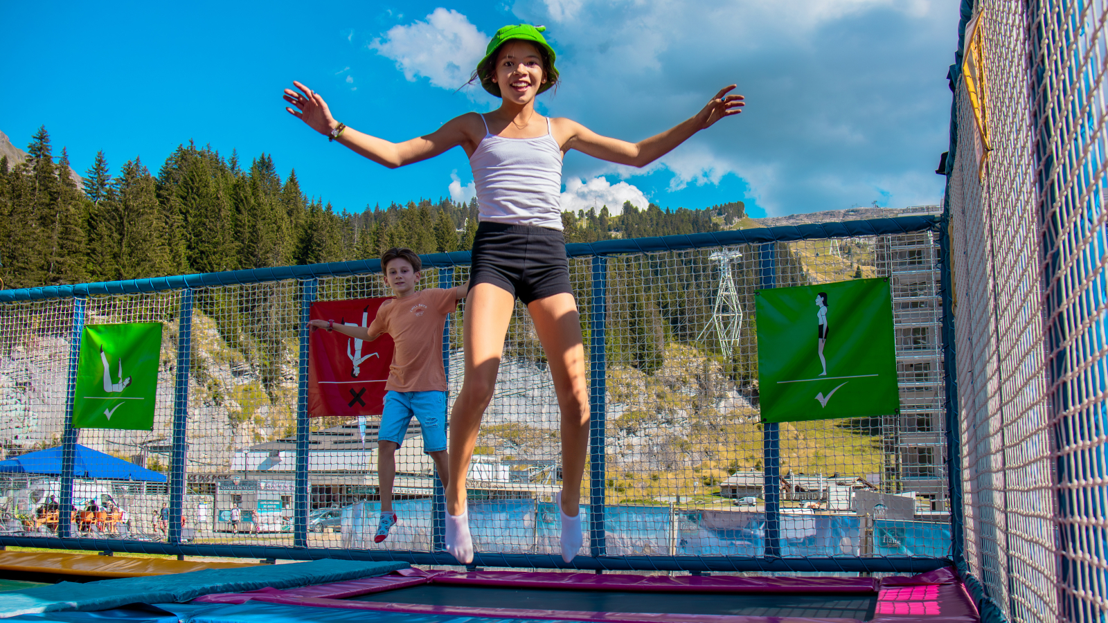 Two children having fun on the trampolines