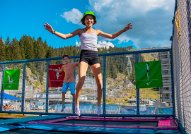 Two children having fun on the trampolines