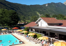 pool deckchairs and restaurant with mountain view