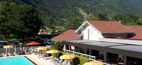 pool deckchairs and restaurant with mountain view