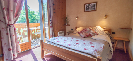 View of bedroom with double bed and balcony