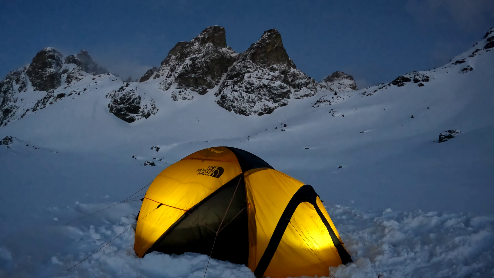 Unusual night in a tent on a frozen lake Chamrousse