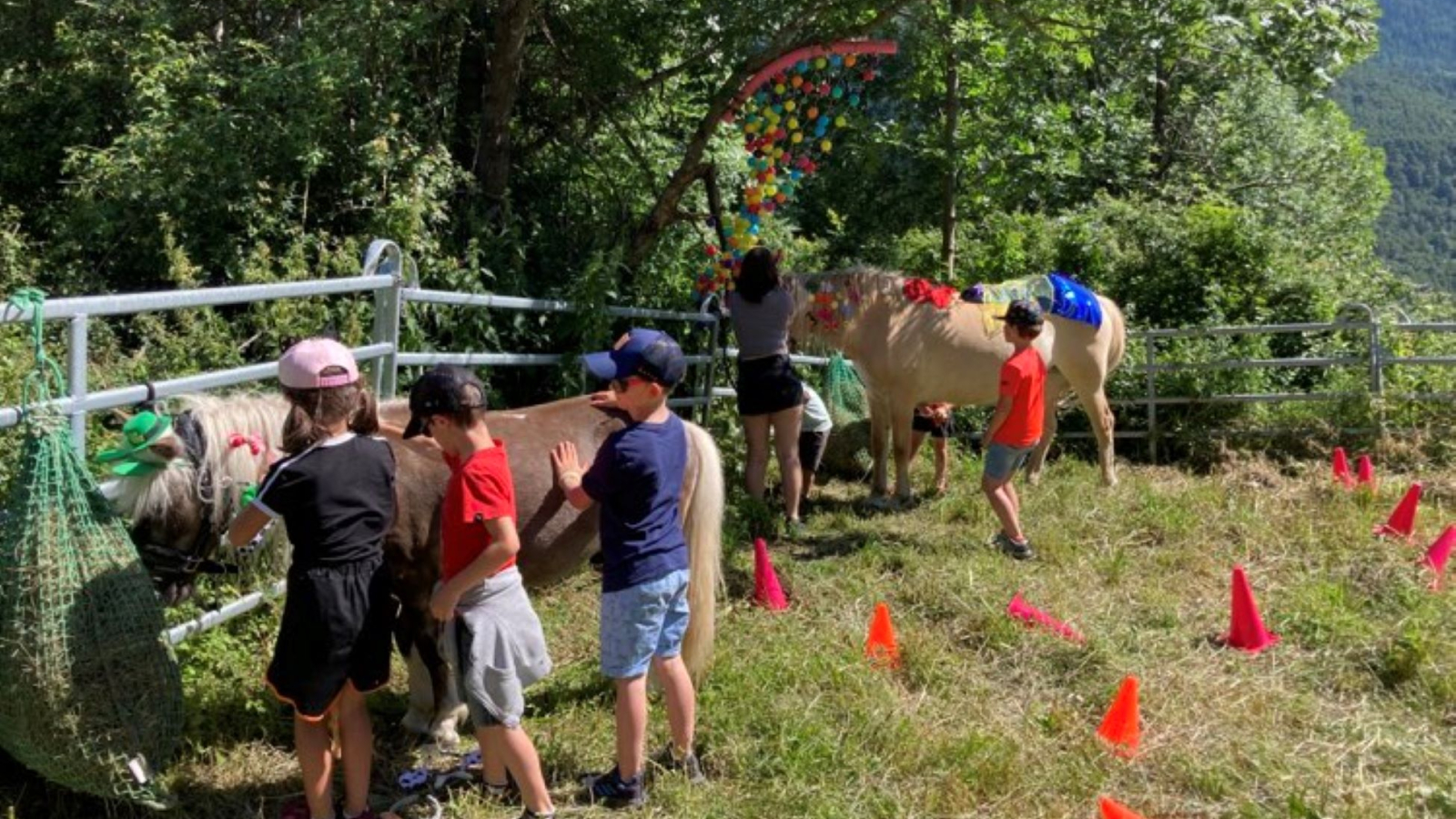 Children around the ponies