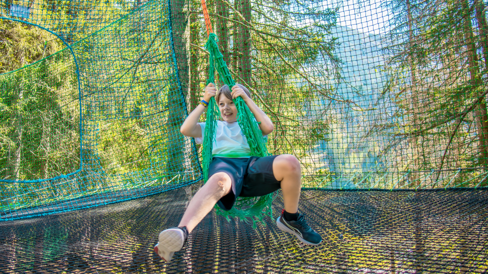 A child sitting on the accro-fun swing