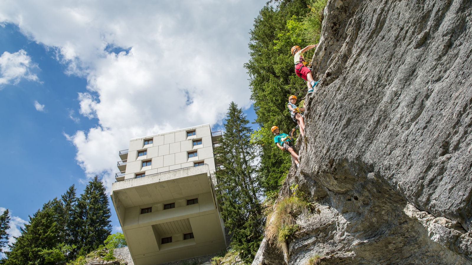 The rope course passing under the cantilevered Le Flaine hotel