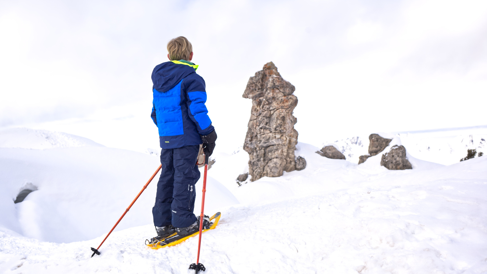 Child enjoying a snowshoe hike