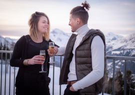 Couple on the terrace of chalet la Fema with a glass of champagne